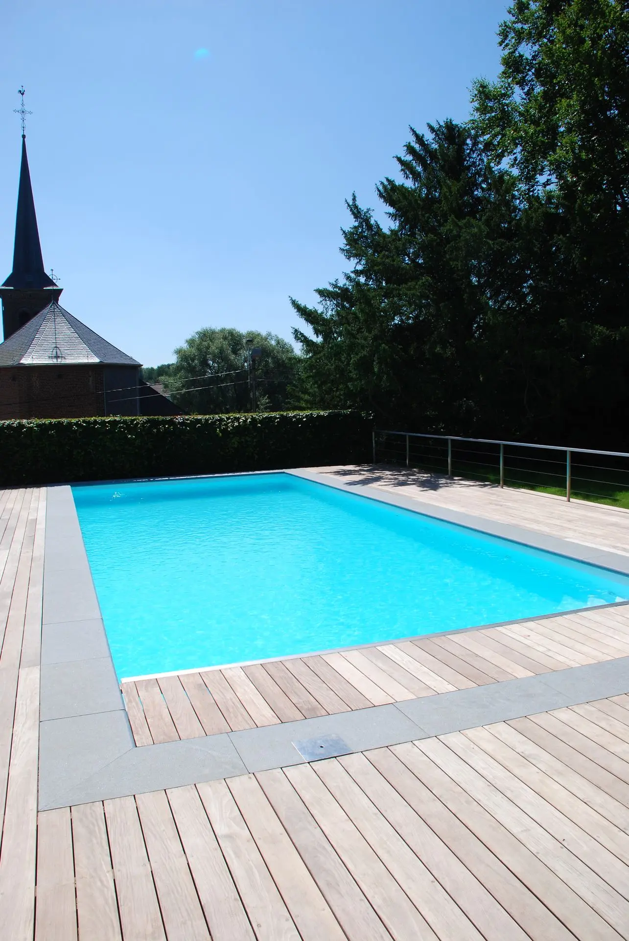 Piscine rectangulaire en bois clair avec eau turquoise — Le Petit Baigneur