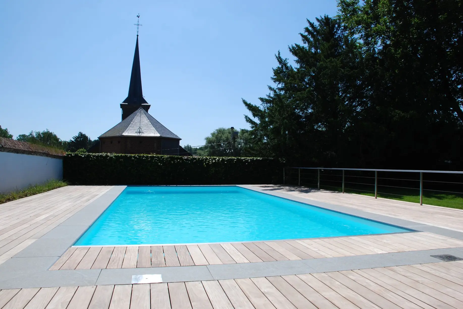 Piscine extérieure bleue lumineuse sous ciel d’été — Le Petit Baigneur